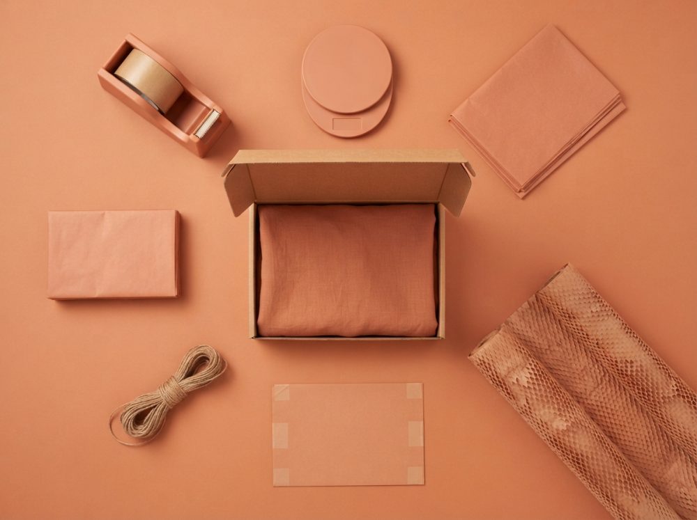 Kit de embalagem em tons terra com caixa, fita adesiva, papel, cordão e etiquetas