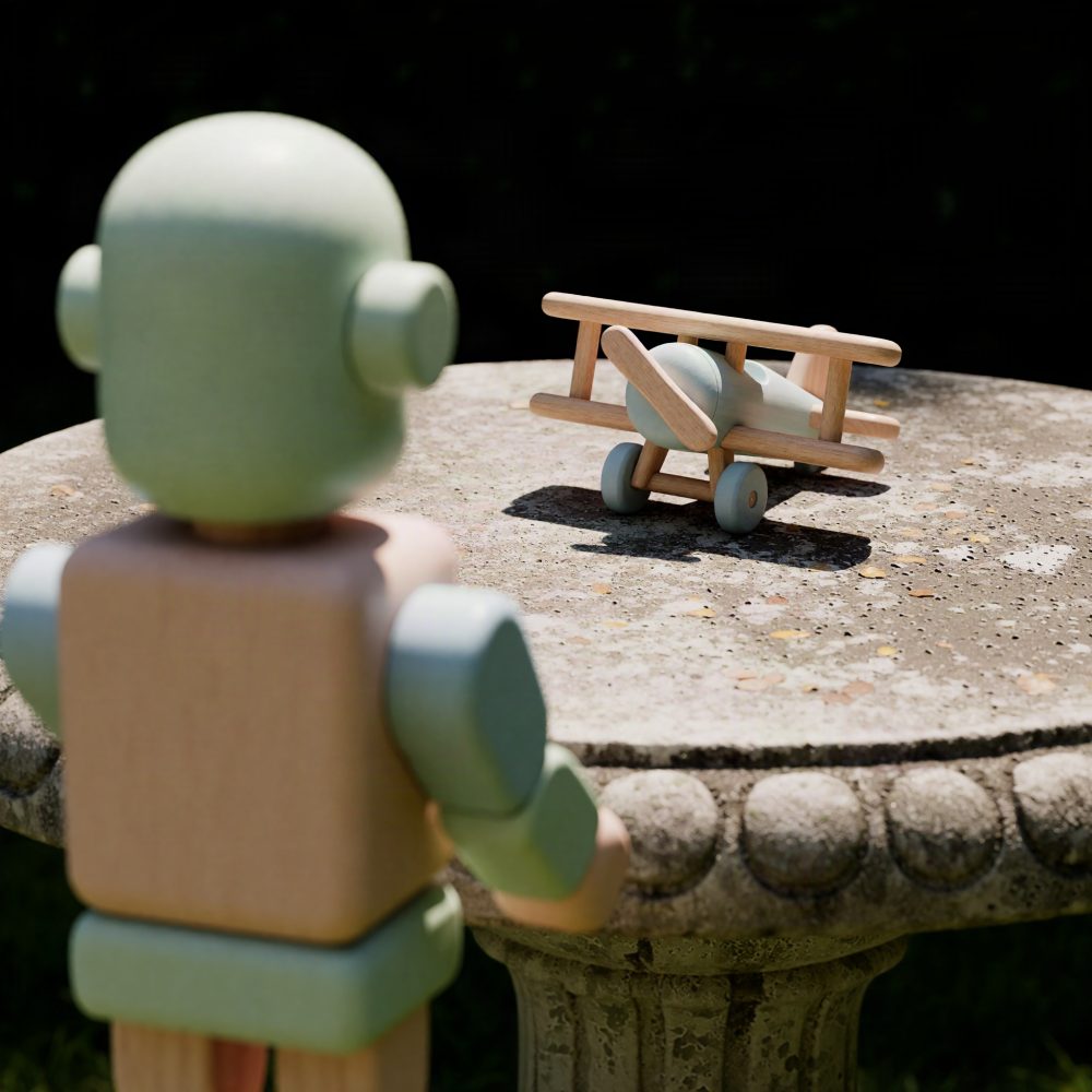 Brinquedo de madeira com avião e figura de robô vintage sobre mesa exterior de pedra