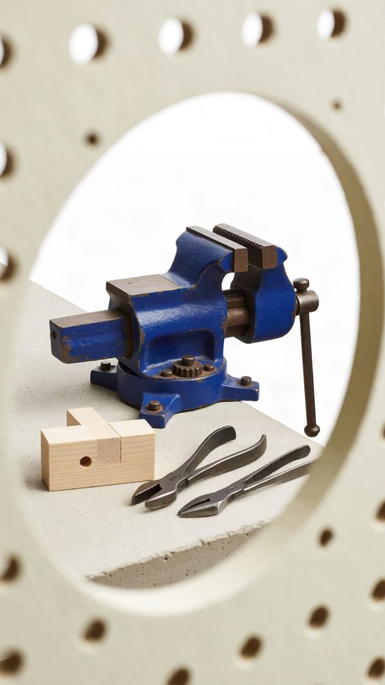 Grampo de bancada azul com alicates e bloco de madeira para bricolage