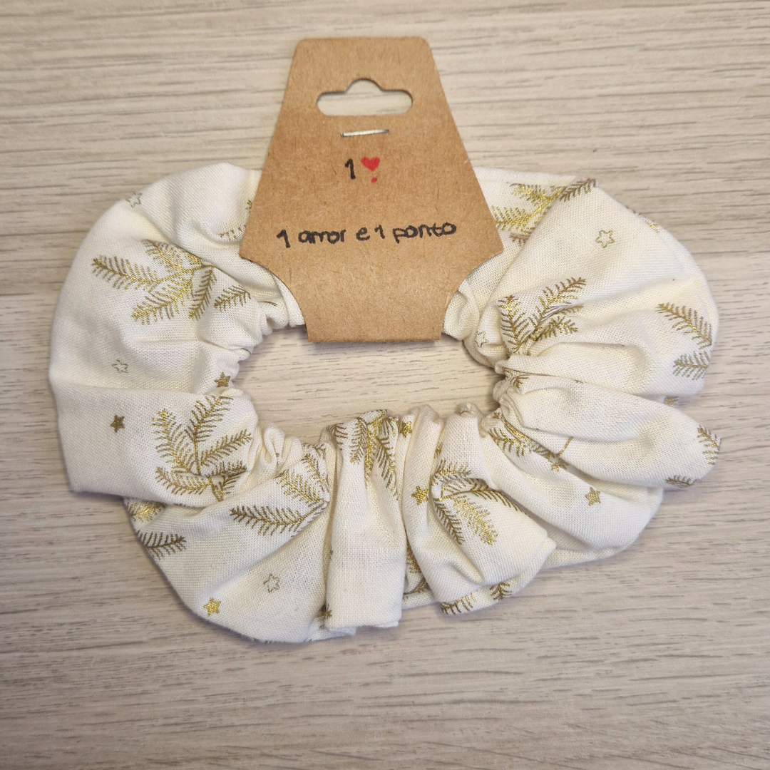 Scrunchie branco com estampas douradas e cartão castanho com texto manuscrito