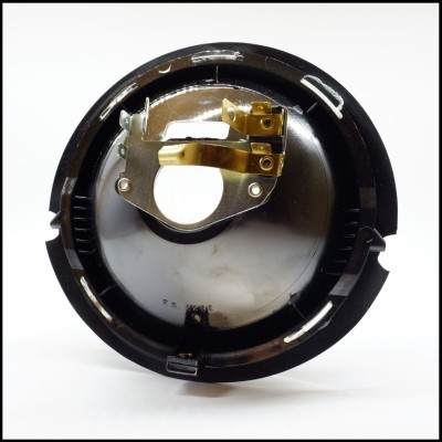 Luz redonda de farol automóvel com suporte metálico dourado e corpo preto