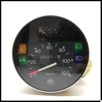 Velocímetro redondo preto com luzes indicadoras coloridas e contador de quilómetros.