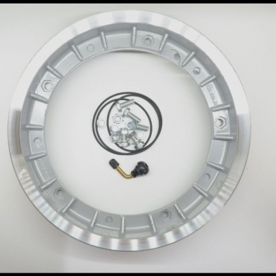 Aro de roda metálico prateado com válvula e peças metálicas pequenas no centro