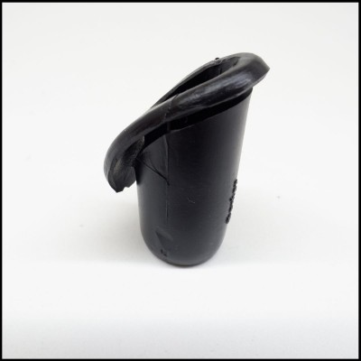Peça plástica preta cilíndrica com borda irregular em fundo branco