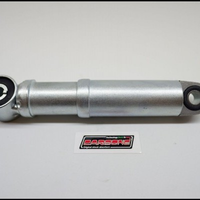 Amortecedor prateado com terminais pretos e etiqueta DARGORE
