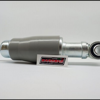 Amortecedor metálico prateado com capa cinza e selo 'DESIGN MOTOS'