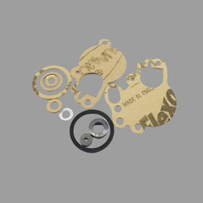 Conjunto de juntas e anilhas de papel e metal em fundo cinzento