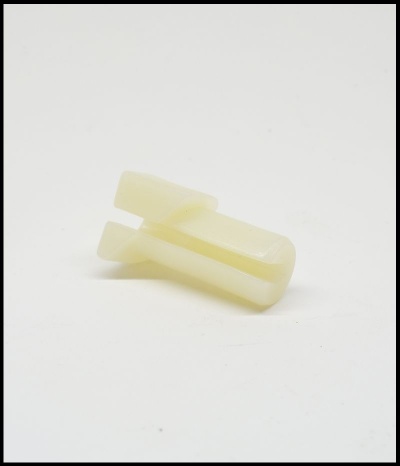 Peça plástica amarelada com fendas