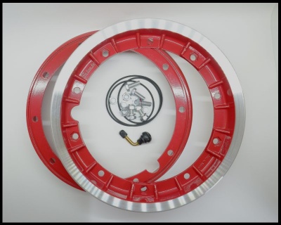 Discos de travão em metal vermelho e prateado com anéis e componente elétrico