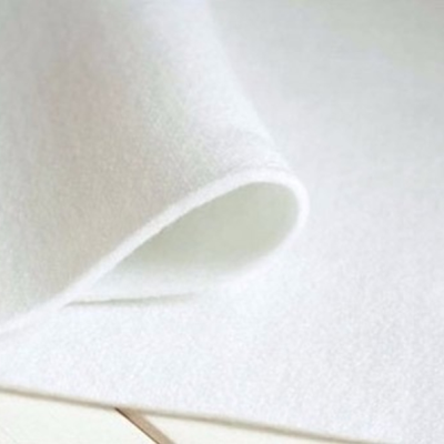 Tapete branco felpudo sobre chão claro de azulejos quadrados