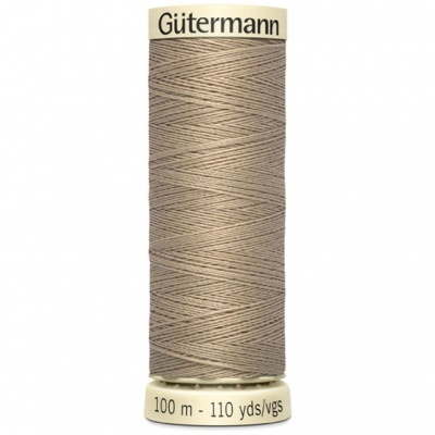 Spool of beige Gütermann sewing thread with brand and length labels