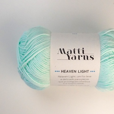 Novelo de fio de lã verde claro com etiqueta branca da marca Matti Yarns Heaven Light