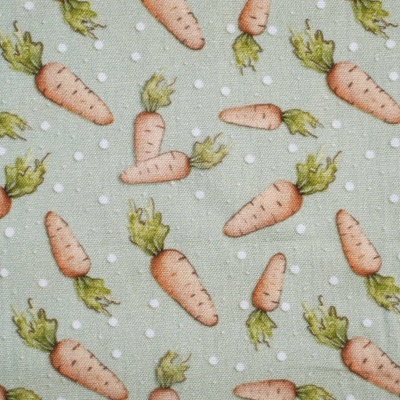 Tecido com padrão de cenouras e pontos brancos