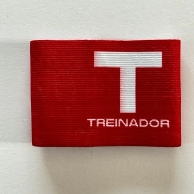 Braçadeira vermelha com texto branco 'TREINADOR'