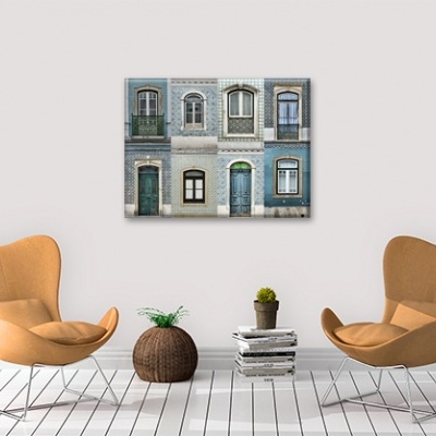 Decoração interior com duas cadeiras castanho claro, vaso de plantas, livros e quadro decorativo com janelas