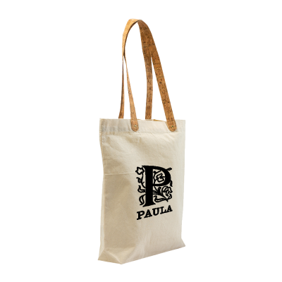 Mala tote de tecido bege com alças castanhas e estampa preta com a letra P e nome Paula