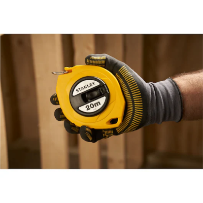 Trena amarela Stanley 20m segurada por mão com luva cinzenta e amarelos