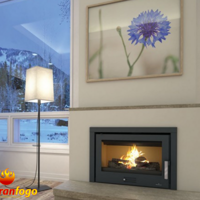 Lareira embutida acesa com abajur e quadro de flor azul em sala com janela grande