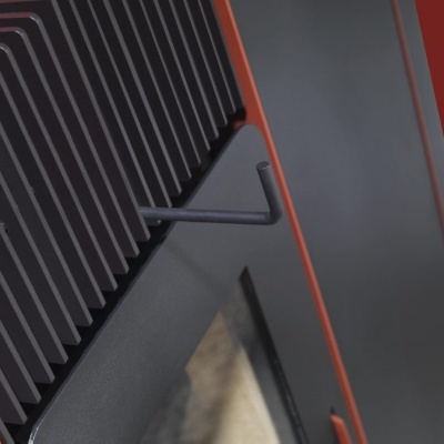 Radiador preto com alavanca em ferro, fundo cinza e detalhes laranja