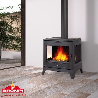 Lareira a lenha preta com vidro a mostrar chama, instalada numa sala moderna.