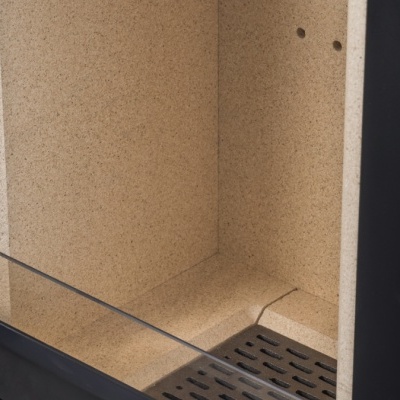 Interior de lareira ou fogão a lenha com revestimento refratário bege, estrutura preta de metal e vidro frontal.