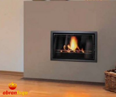 Lareira embutida com fogo aceso numa parede cinza