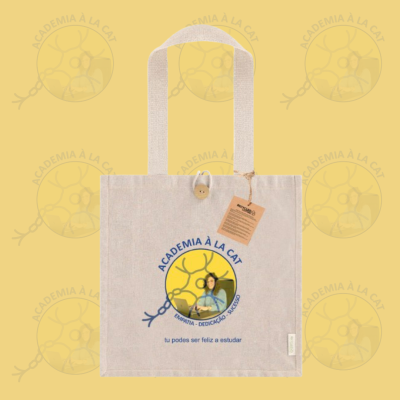Saco de tecido bege com impressão ACADEMIA À LA CAT e uma imagem circular amarela