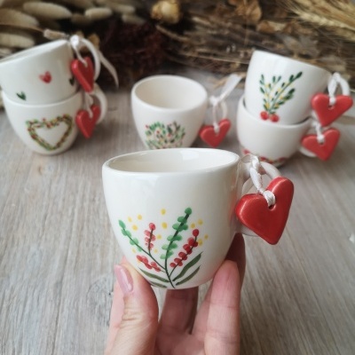 Chávenas de cerâmica branca com desenhos coloridos e pendente de coração vermelho