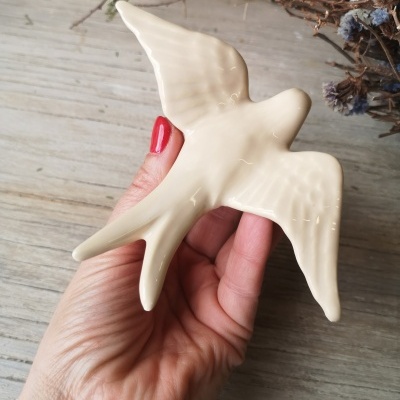 Figura decorativa de pássaro branco em cerâmica na mão