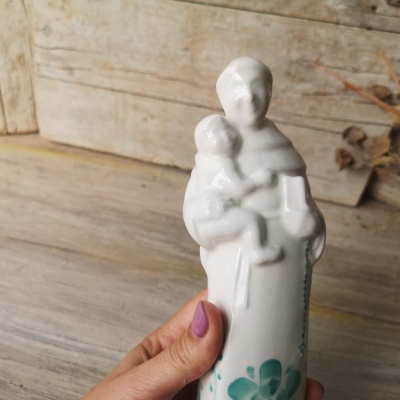 Figura de cerâmica branca de mulher e criança com padrão floral verde