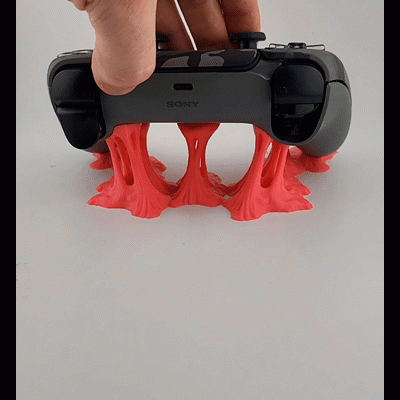 Comando de videojogo Sony preto com base decorativa vermelha elástica