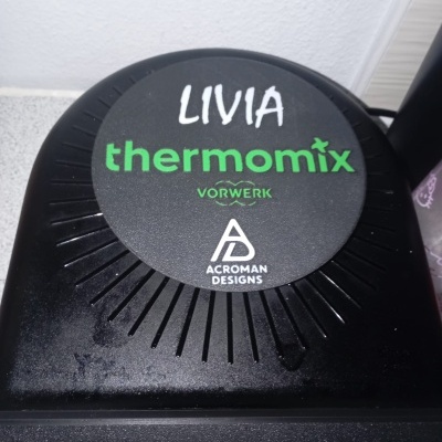 Tampa preta de eletrodoméstico com texto e logo