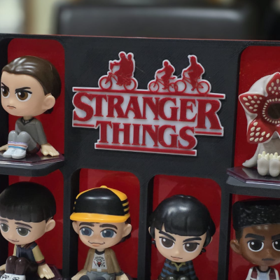 Expositor com seis figuras colecionáveis de Stranger Things e logo em relevo