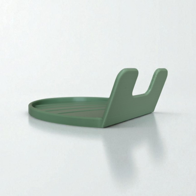 Base de suporte verde para telemóvel ou tablet contra parede branca