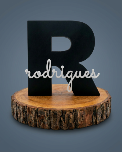Letra decorativa preta R com nome rodrigues branco sobre base de madeira