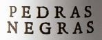 Texto 'PEDRAS NEGRAS' em letras maiúsculas pretas sobre fundo branco