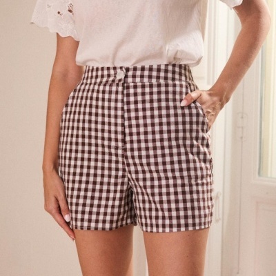 Shorts xadrez castanho e branco com t-shirt branca de mangas curtas bordadas