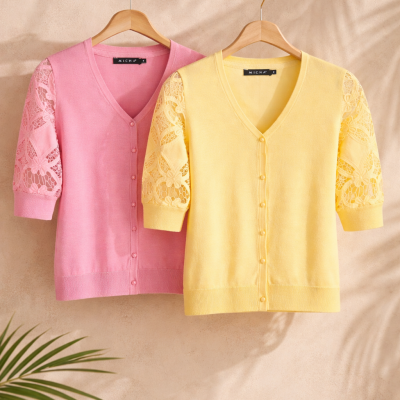 Cardigans rosa e amarelo com mangas em renda pendurados em ramo de madeira
