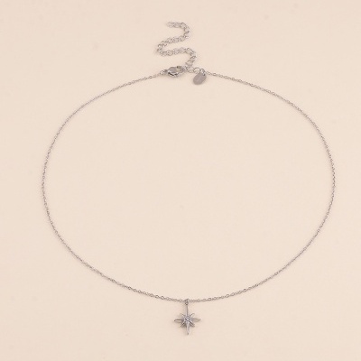 Colar prata com pendente estrela em fundo bege