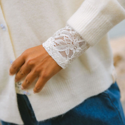 Punho de camisola creme com renda branca floral e calças de ganga azul