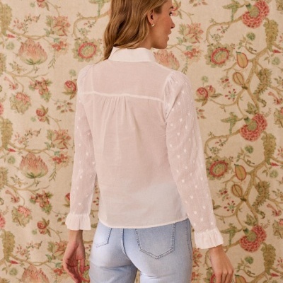 Blusa branca feminina com mangas transparentes compridas e padrão de corações em fundo com padrão floral.