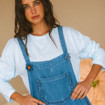 Vestido jardineira de ganga azul com bolso frontal e alças com botões laranja