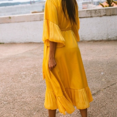 Vestido amarelo midi com mangas largas e acabamentos plissados em zona exterior