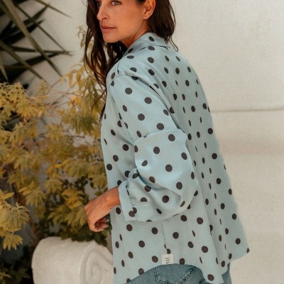 Camisa azul clara com bolinhas pretas usada por mulher com jeans