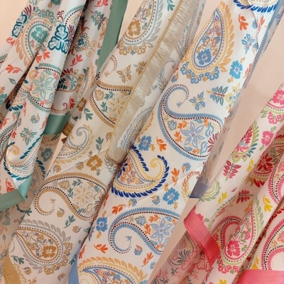 Lenços coloridos pendurados com padrão floral e bordas lisas