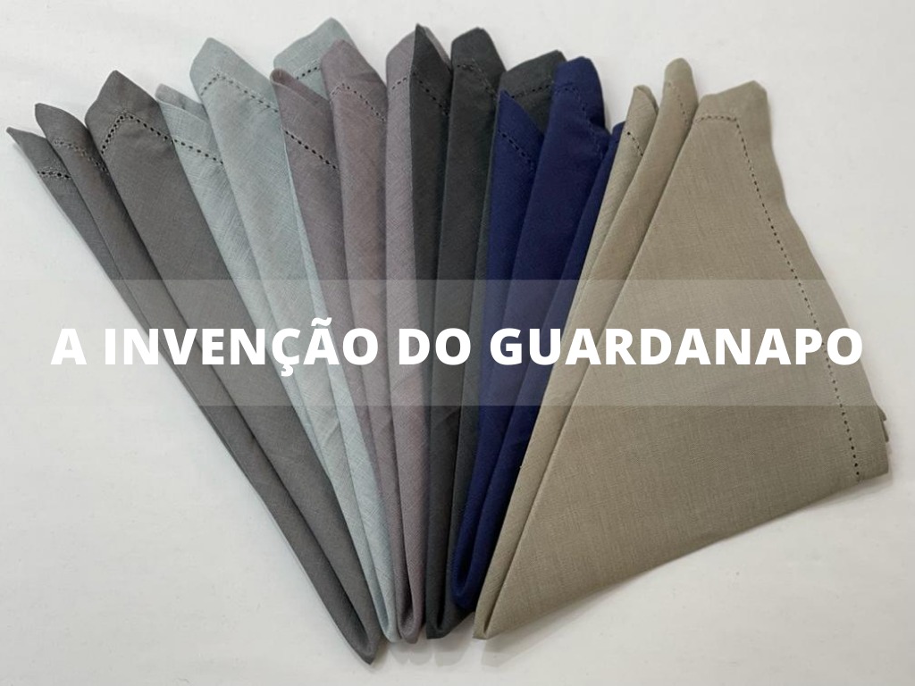 Guardanapos de tecido em várias cores neutras e escuras dispostos em leque com texto acima.