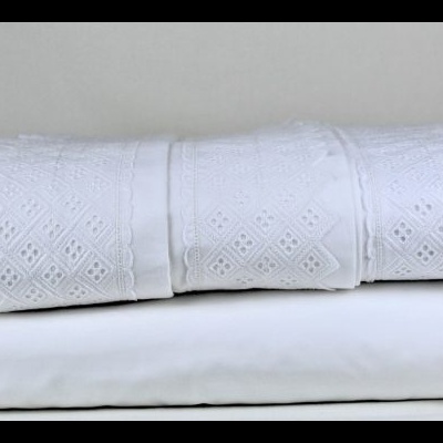 Conjunto de roupa de cama branco com faixa de renda decorativa em losangos