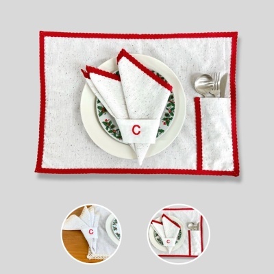 Conjunto de mesa branco com borda vermelha, guardanapos, prato decorativo e talheres