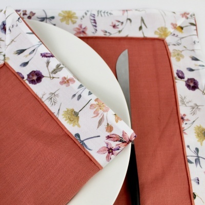 Conjunto de acessórios de mesa com padrão floral e tecido terracota