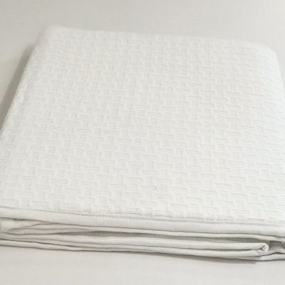 Lençol branco dobrado com padrão texturizado